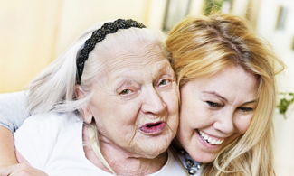 Bild på en glad äldre kvinna och en glad yngre kvinna